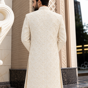 Men’s ivory embroidered sherwani with intricate damask pattern and traditional collar